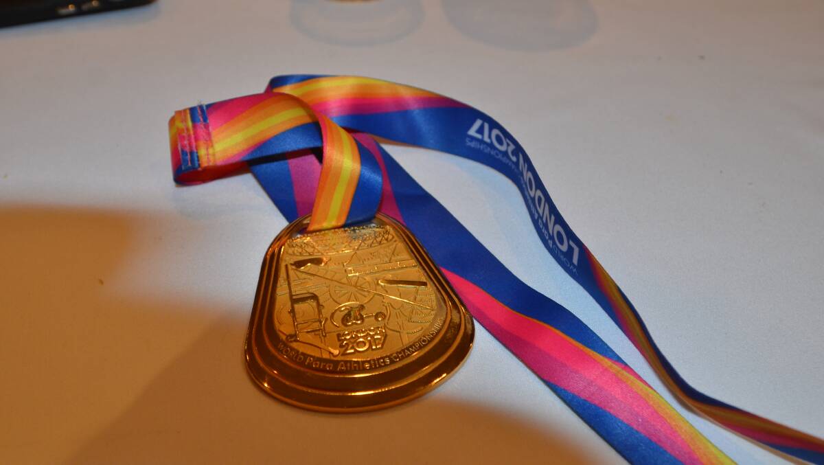 Scott Reardon's gold medal was passed around the crowd while he gave his presentation.