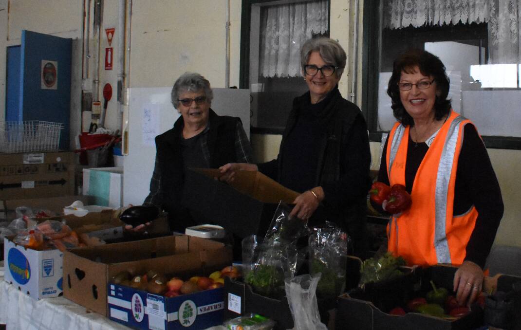 Young Food Hall volunteers Jenny Howell, Cr Marg Roles and Beverley Harris. The group received $1000 from council. Photo: Peter Guthrie