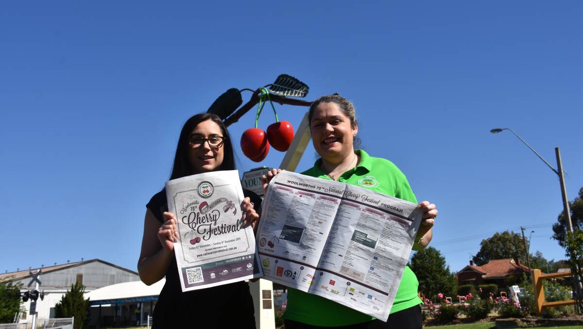 Hilltops Council Destination Marketing and Events Officer Emma Hill with Caitlin Sheehan, National Cherry Festival President and today's 16-page feature insert.