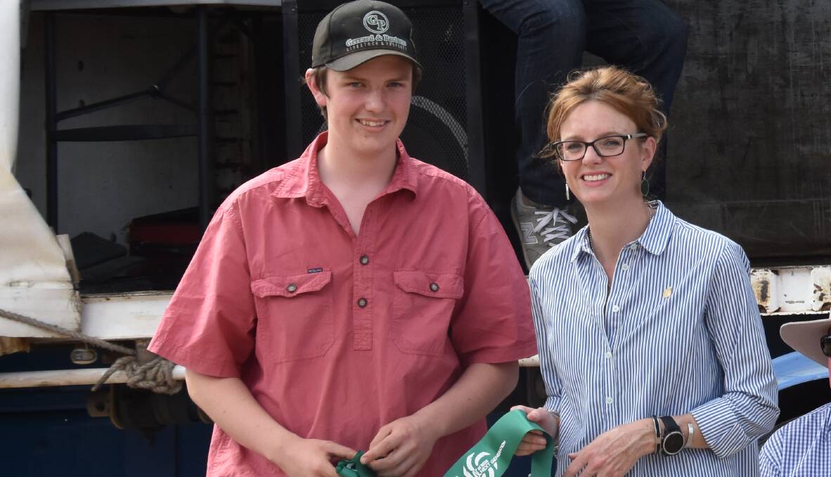 Liam Hunter receives a Next Generation ribbon from Member for Cootamundra Steph Cooke at Bribbaree Show on Saturday. Photo: Penny Le Poidevin
