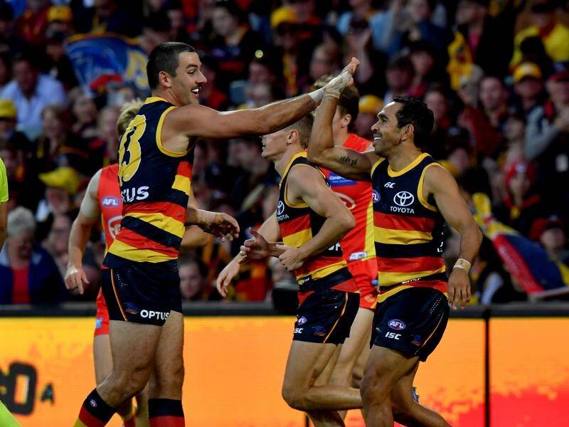 Adelaide's Eddie Betts (r) has marked his 300th AFL match with six goals against Gold Coast.