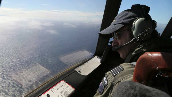 Royal New Zealand Air Force P-3 Orion's captain, Wing Commander Rob Shearer watches out of the window of his aircraft while searching for the missing Malaysia Airlines Flight MH370 in the southern Indian Ocean. Photo: AP Photo