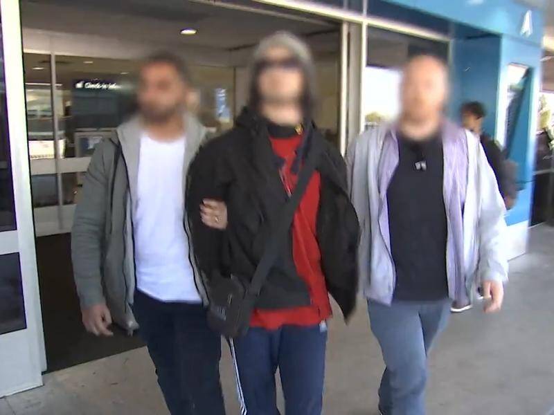 Moudasser Taleb (centre) was arrested at Sydney airport allegedly attempting to travel to Syria.