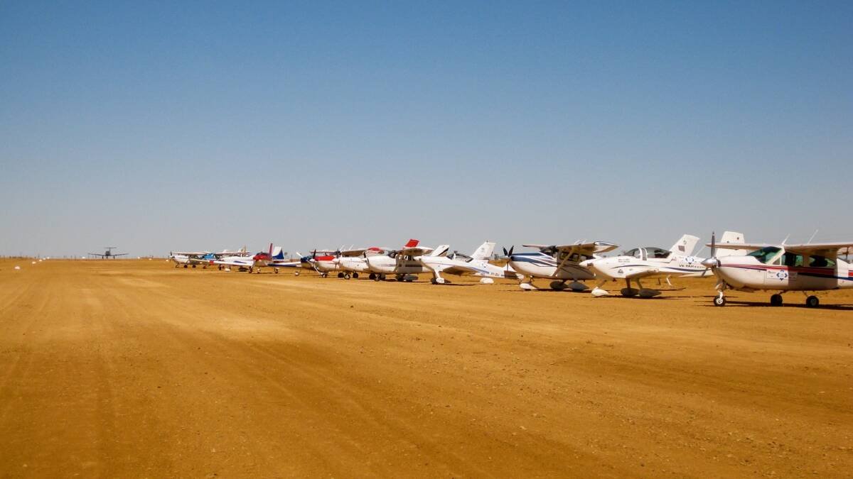 RECORD BREAKER: Steadfast Outback Air Race planes line up for a lunch break, day seven, on the dirt strip at Davenport Downs, Queensland and Paraway’s largest cattle station at almost four million acres. 										(sub)