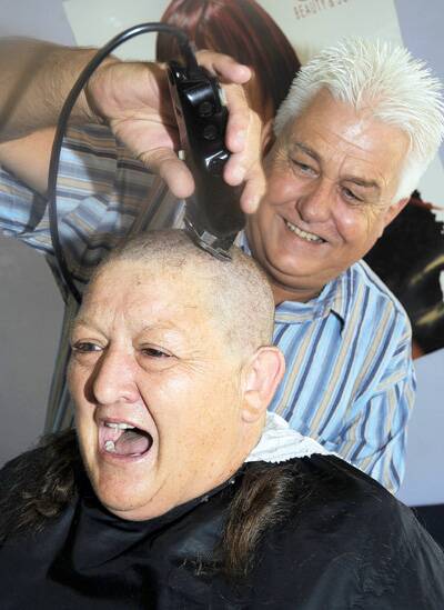CLOSE SHAVE: Wagga hairdresser John Roy had the honour of shaving off all of Robyn Annetts’ hair for charity yesterday. The head shave was not Ms Annetts’ first time, having done it two years ago.