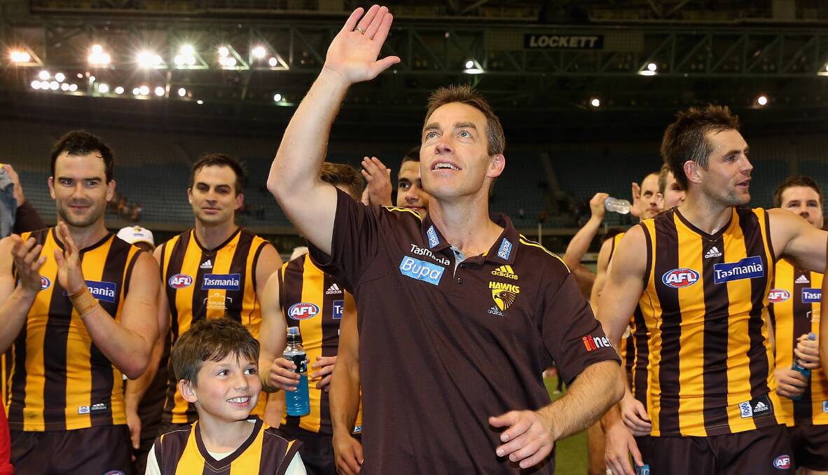 Alastair Clarkson the coach of the Hawks waves to the fans after coaching his 200th game. Photo: Getty Images.