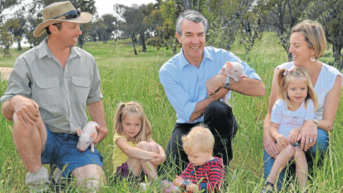 ALL SMILES: Parliamentary Secretary for Climate Change and Energy Efficiency Mark Dreyfus (centre) with farm owners Michael and Edwina Beveridge, and their children Alice, Sam and Sophie (left to right). 
