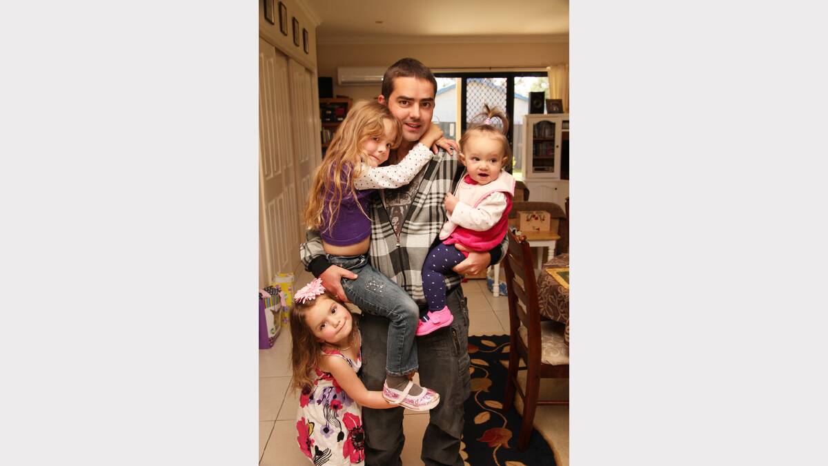 LITTLE MONKEYS: Adele Pardy sent in this photo from two years ago of her husband Stewart Pardy and daughters Mikayla, 8, Willow, 6, and Indigo, 3. “This is a photo of my husband with his daughters hanging off him for father’s day. My daughter Mikayla, aged 8, asked me to send it in.”