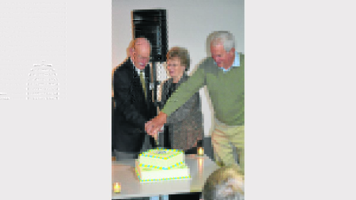 CELEBRATE: Cutting the cake were former manager John Finlayson from 1963 to 1969, Children’s presenter Yvonne Graham (nee Symons) during the 1950s, and former announcer John Thompson. 