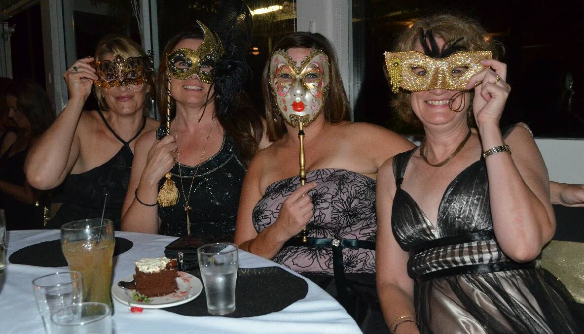 BEHIND THE MASK! Mel Everdel, Bernie Page, Donna Cummins and Michelle Maloney show-off their range of masks at the masquerade ball last Friday.    Photos by Christine Speelman